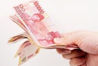 Ilustrasi uang bansos (Foto: Getty Images/iStockphoto/Yoyochow23)